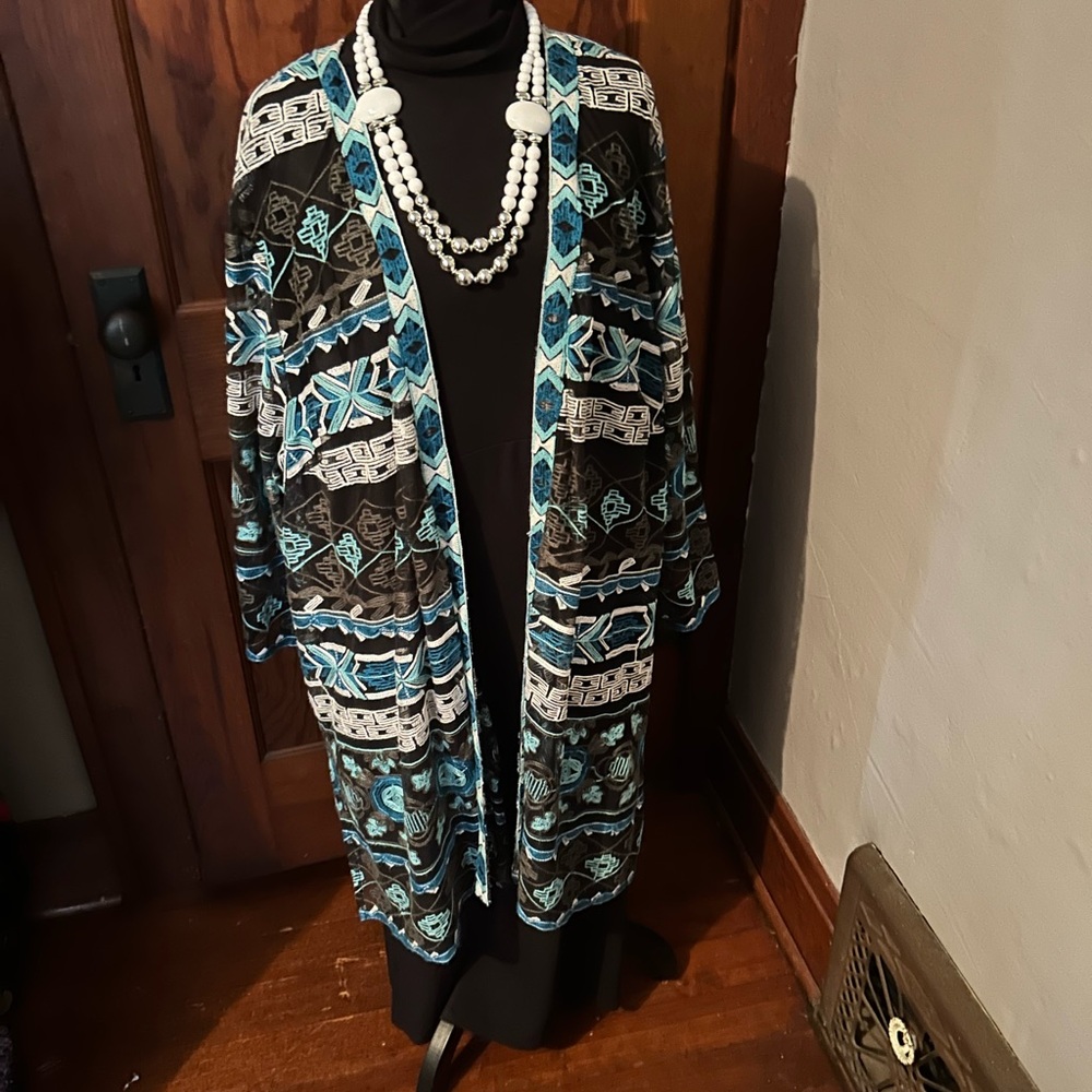 Black dress with a cover-up and a necklace